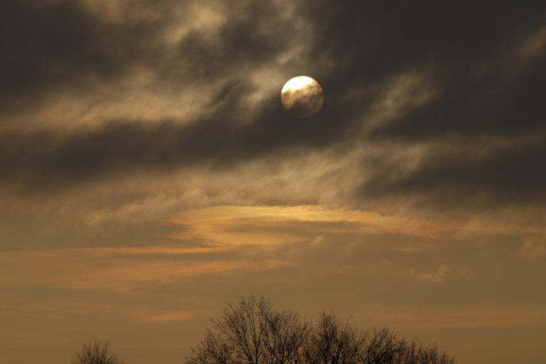 sun behind the clouds